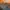 Ariel view of city skyline at sunset with boats on river.